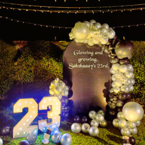 Silver and black balloon arch with 23 marquee lights for birthday decor in Jaipur