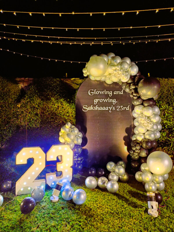 Silver and black balloon arch with 23 marquee lights for birthday decor in Jaipur