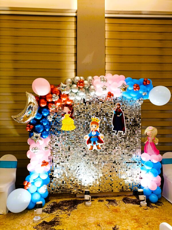 Royal Prince and Princess themed balloon decoration with character cutouts and sequin backdrop in Jaipur.