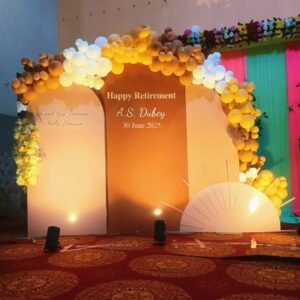 Elegant retirement party decoration in Jaipur with a sunset-themed balloon garland and custom backdrop for A.S. Dubey's farewell.