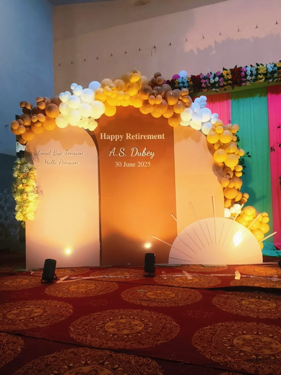 Elegant retirement party decoration in Jaipur with a sunset-themed balloon garland and custom backdrop for A.S. Dubey's farewell.