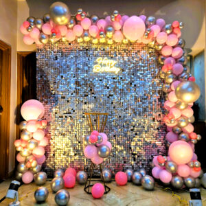 Luxury pink and silver sequin wall birthday decoration in Jaipur with balloon arch and neon sign. Perfect for elegant home and hotel celebrations.