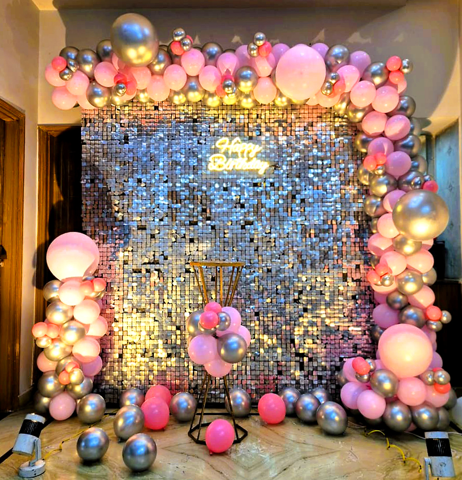 Luxury pink and silver sequin wall birthday decoration in Jaipur with balloon arch and neon sign. Perfect for elegant home and hotel celebrations.