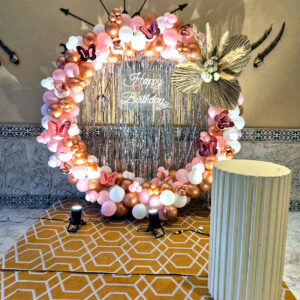 Premium butterfly theme birthday balloon decoration in Jaipur featuring LED ring, fringe backdrop, and elegant pastel balloon setup.